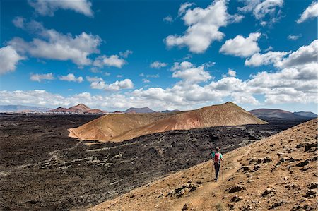 Hiker, Caldera Blanca view towards Montana Caldereta, Lanzarote, Canary Islands, Spain Stock Photo - Rights-Managed, Code: 862-08091229