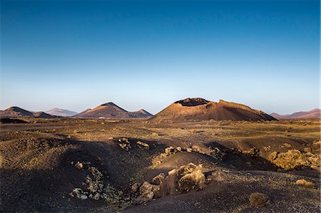 Crater Montana del Cuervo in front of Timanfaya Nationalpark, Parque de los Volcanes, Lanzarote, Canary Islands, Spain Stock Photo - Rights-Managed, Code: 862-08091240
