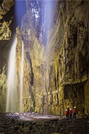 simsearch:862-08273057,k - United Kingdom, England, North Yorkshire, Clapham. The main chamber of Gaping Gill during a twice yearly winch meet when non cavers can experience the largest underground chamber and unbroken waterfall in England. The main chamber is 322ft deep and is comparable to York Minster in volume. . Stockbilder - Lizenzpflichtiges, Bildnummer: 862-08273054