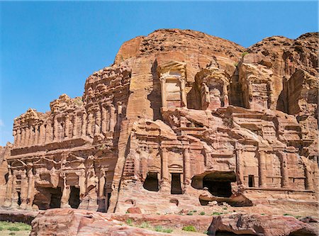 petra - Jordan, Petra.  Two of the Royal Tombs exquisitely carved into a hillside of pink sandstone. The Palace Tomb on the left is named after its regal appearance. The tomb on the right is the Corinthian Tomb. Stock Photo - Rights-Managed, Code: 862-08273508