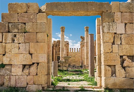 roman ruins middle east - Jordan, Jerash.  The 6th century ruins of the Byzantine Church of the Propylaea viewed through the  Cardo  to the Propylaeum   the gateway leading to the Temple of Artemis in the ancient Roman city of Jerash. Stock Photo - Rights-Managed, Code: 862-08273501