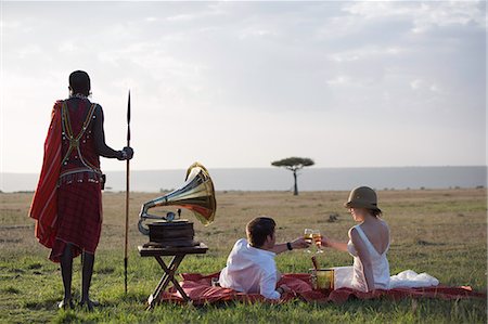 sunset safari - Kenya, Mara North Conservancy. A newly wed couple toast with Champagne in the Mara. Stock Photo - Rights-Managed, Code: 862-08273600