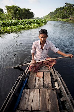 Jessore, Bangladesh. A traditional boatman transports goods on the tributaries of the Ganges-Brahmaputra delta. Stock Photo - Rights-Managed, Code: 862-08698683