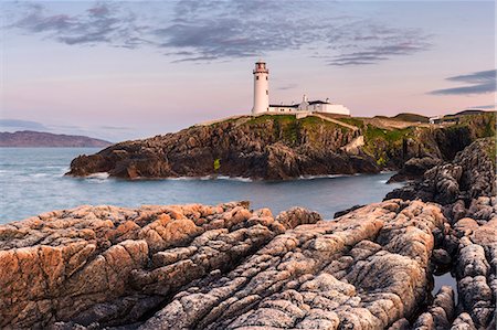 sea cliffs donegal - Fanad Head (Fánaid) lighthouse, County Donegal, Ulster region, Ireland, Europe. Panoramic view of the lighthouse and its cove at dusk. Stock Photo - Rights-Managed, Code: 862-08699391