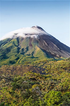 Costa Rica, Alajuela Province, Arenal.  Arenal Volcano with steam rising from its peak.  This active stratovolcano erupted last in 2010. Stock Photo - Rights-Managed, Code: 862-08704758