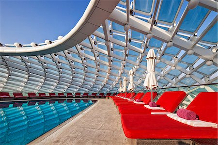 simsearch:862-07910882,k - Comfortable relaxing pool side recliners beside the pool at the Yas Viceroy Abu Dhabi Hotel, Yas West, Abu Dhabi, United Arab Emirates. Stock Photo - Rights-Managed, Code: 862-08705058
