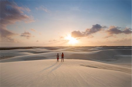 simsearch:862-08718474,k - Brazil, Maranhao, Atins, Lencois Maranhenses national park, people standing in the dunes near Atins town watching the sunrise Stock Photo - Rights-Managed, Code: 862-08718472