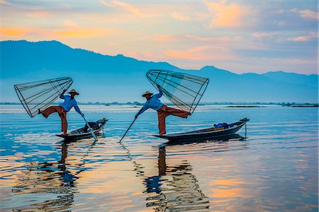 Inle lake, Nyaungshwe township, Taunggyi district, Myanmar (Burma). Local fishermen with typical conic fishing net. Stock Photo - Rights-Managed, Code: 862-08719286