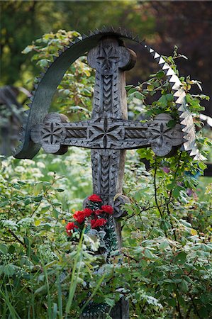 Romania, Maramures, Breb. A carved wooden cross marking a grave in the cemetery. Stock Photo - Rights-Managed, Code: 862-08719415