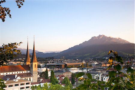 Switzerland, Lake Lucerne. The Hof Church overlooking the city across Lake Lucerne and the Swiss Alps in the background. Stock Photo - Rights-Managed, Code: 862-08719634