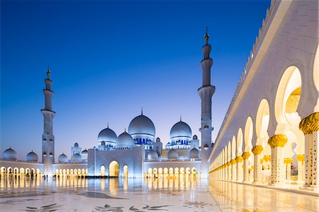 simsearch:862-07910888,k - United Arab Emirates, Abu Dhabi. The courtyard and white marble exterior of Sheikh Zayed Grand Mosque. The spectacular evening lighting varies from white to blue according to the phases of the moon. Stock Photo - Rights-Managed, Code: 862-08719909