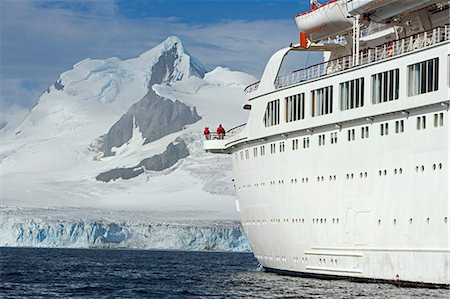 The Mountains of the Livingstone Range and Island at the stern of the MV Discovery during a landing at Half Moon Bay in Antarctica. Stock Photo - Rights-Managed, Code: 862-03288477