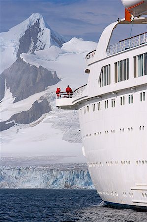 The mountains of the Livingstone Range and island at the stern of the MV Discovery during a landing at Half Moon Bay in Antarctica. Stock Photo - Rights-Managed, Code: 862-03288479