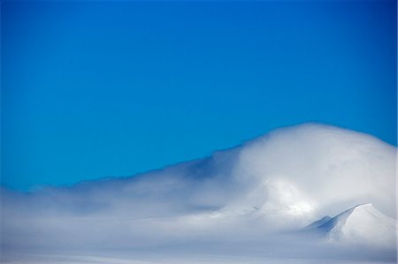 simsearch:862-03288559,k - Antarctica,Antarctic Peninsula. Peaks on Livingstone Island cloaked in clouds shaped by higher altitude winds. Stock Photo - Rights-Managed, Code: 862-03288490
