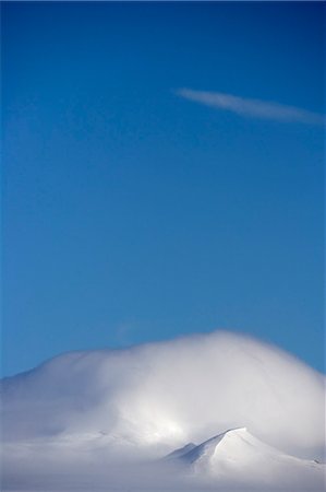 simsearch:862-03288559,k - Antarctica,Antarctic Penisula. Peaks on Livingstone Island cloaked in clouds shaped by higher altitude winds. Stock Photo - Rights-Managed, Code: 862-03288491