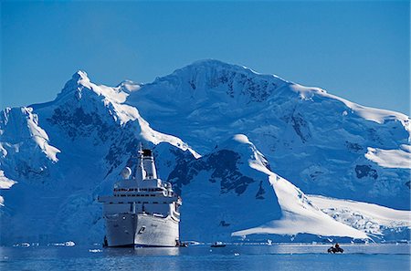 Zodiac and passengers going ashore at the Chilean base in Paradise Harbour on the Antarctic Peninsula. Stock Photo - Rights-Managed, Code: 862-03288599
