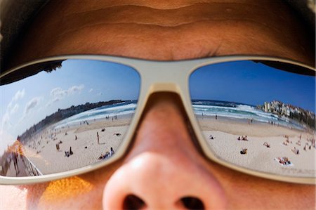Blue skies over Bondi Beach are reflected in the sunglasses of a visitor to Sydney's iconic beach Stock Photo - Rights-Managed, Code: 862-03288817