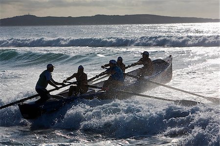A surfboat crew battles through the waves at Cronulla Beach in Sydney. Surfboat racing are a major event during surf lifesaving carnivals on Australian beaches. Stock Photo - Rights-Managed, Code: 862-03288879
