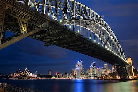 sydney night lights - The Sydney Opera House and city skyline is framed by the illuminated Harbour Bridge Stock Photo - Rights-Managed, Code: 862-03288873