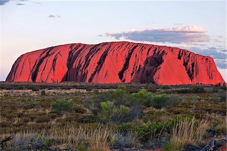 Australia,Northern Territory. Uluru or Ayres Rock,a huge sandstone rock formation,is one of Australia’s most recognized natural icons. The rock appears to change colour in different lights. Stock Photo - Rights-Managed, Code: 862-03289179