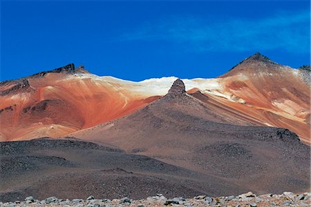 Cerro Rosario,one of the volcanic Andean peaks rising above the altiplano,gets its name from the red streaks of minerals on its upper slopes. Stock Photo - Rights-Managed, Code: 862-03289415