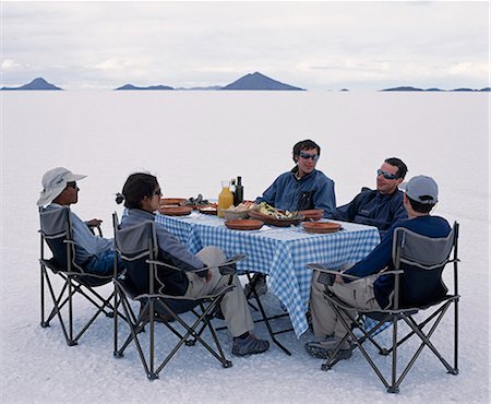 simsearch:862-03289455,k - Guests on the Explora Traversia of southern bolivia enjoy lunch set out on the salt crust of the Salar de Uyuni,the largest salt flat in the world at over 12,000 square kilometres. Stock Photo - Rights-Managed, Code: 862-03289466
