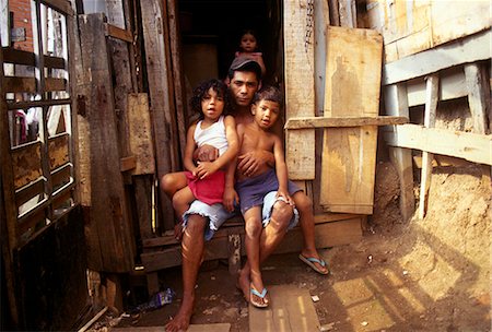 fauchée - Une famille dans l'embrasure de la porte de leur maison dans une favela de Sao Paulo Photographie de stock - Rights-Managed, Code: 862-03289637