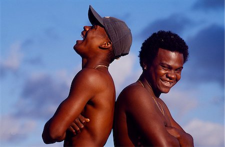 Two teenage boys laugh and joke in Sao Paulo sunshine. Stock Photo - Rights-Managed, Code: 862-03289643