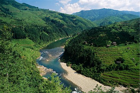 Nr Rongjiang,Guizhou ProvinceIsolated hamlets share limited flat land with terraced rice paddies in a tributary valley of the Duliu River. Guizhou is considered the least developed and remotest of China's southern provinces Stock Photo - Rights-Managed, Code: 862-03289892
