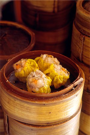 dimsum - Dim sum delicacies are stacked in steaming bamboo baskets in a Kowloon restaurant,Hong Kong Stock Photo - Rights-Managed, Code: 862-03289946