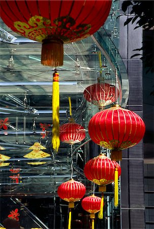 Traditional Chinese lanterns celebrating the lunar New Year contrast with the glass and metal construction of a modern skyscraper in Central,on Hong Kong island Stock Photo - Rights-Managed, Code: 862-03289963