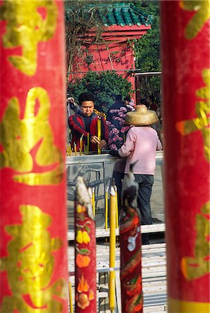 simsearch:855-03022365,k - Looking through giant joss sticks to a visitor making an incense offering at the Po Lin Monastery on Lantau Island,Hong Kong Stock Photo - Rights-Managed, Code: 862-03289970