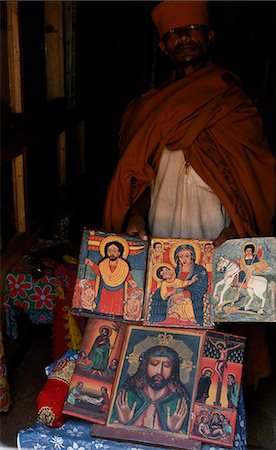 A priest at Kebran Gabriel Church shows several of its many ancient illustrated books; the church has the largest library in the Tana region. Foto de stock - Con derechos protegidos, Código: 862-03354024