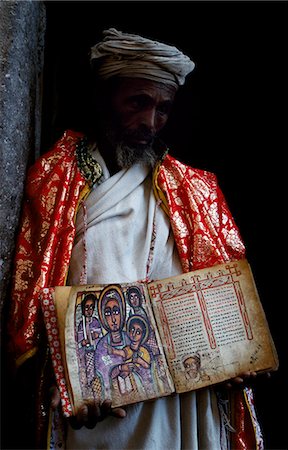 A priest holds one of the monastery's ancient illuminated texts. Stock Photo - Rights-Managed, Code: 862-03354021