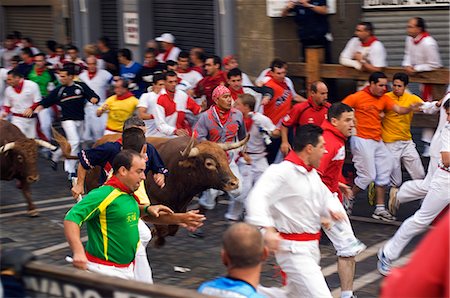 fiesta san fermin - San Fermin Running of the Bulls Festival. The celebration,which honours the city's patron saint,San Fermin - includes fireworks,parades,dances,bullfights and religious ceremonies. Stock Photo - Rights-Managed, Code: 862-03354472