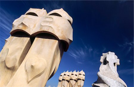 spain barcelona city - The surreal chimneys of Antoni Gaudi's architectural icon,Casa Mila in Barcelona. Known as La Pedrera (the Quarry),the builiding was built from 1905 to 1911 and declared a UNESCO World Heritage Site in 1984. Stock Photo - Rights-Managed, Code: 862-03354484