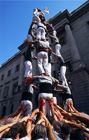 focus group - A castell (human castle) nears completion as the last performers scramble to the top,during the festival of La Merce in Barcelona. The formation of castells (human towers) is a Catalan tradition usually performed at festivals throughout Catalunya. Stock Photo - Rights-Managed, Code: 862-03354490