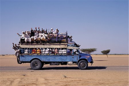 shendi - An over-crowded old Bedford bus travels along the main road from Khartoum to Shendi,a centuries old market town on the River Nile. Stock Photo - Rights-Managed, Code: 862-03354574