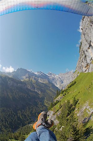 Switzerland,Bernese Oberland,Murren. A paraglider taking in the alpine views over Murren. Stock Photo - Rights-Managed, Code: 862-03354742