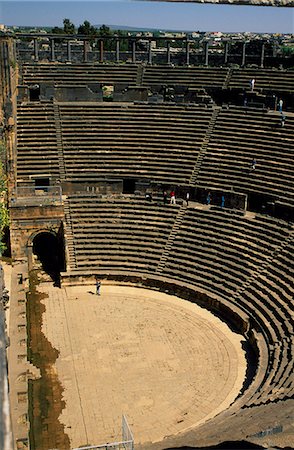 simsearch:862-03354820,k - Originally built by the Romans,Bosra's 15,000 seat amphitheatre was gradually fortified from the 7th century on by successive Arab dynasties; it remains among the best preserved Roman theatres. Stock Photo - Rights-Managed, Code: 862-03354767