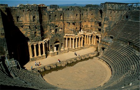 simsearch:862-03354820,k - Originally built by the Romans,Bosra's 15,000 seat amphitheatre was gradually fortified from the 7th century on by successive Arab dynasties; it remains among the best preserved Roman theatres. Stock Photo - Rights-Managed, Code: 862-03354768