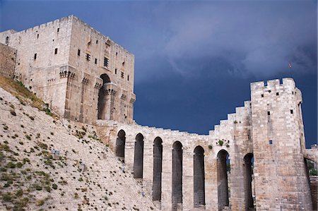 simsearch:862-03354820,k - The Citadel before a storm,Aleppo. There has been a fortress on the site since at least 350BC,but most of the remains today date from the Mamluks in the 13th and 14th centuries. Stock Photo - Rights-Managed, Code: 862-03354820