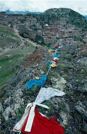 Prayer flags strung among the rocky hills near Ganden Monastery. High on a ridge above the Kyi Chu Valley,the 14C Ganden Monastery suffered extensive damage during the Cultural Revolution in the 1960's. It is now being rebuilt. Stock Photo - Rights-Managed, Code: 862-03354987