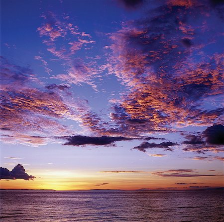 Sunset over Lake Tanganyika.Lake Tanganyika,an immense inland sea set in a long,low,deep trough of the Western Rift,is the biggest lake of Africa's Great Rift Valley system. Its 410-mile-length distinguishes it as the longest freshwater lake in the world. With a depth of 4,710 feet,it is also the world's second deepest; only Lake Baikal in eastern Siberia is deeper. Foto de stock - Con derechos protegidos, Código: 862-03355158