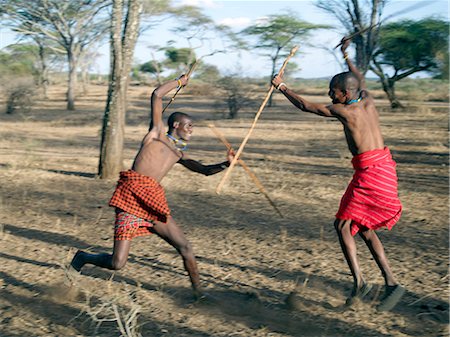 Two Datoga men participate in a mock stick fight. The Datoga (known to their Maasai neighbours as the Mang'ati and to the Iraqw as Babaraig) live in northern Tanzania and are primarily pastoralists. Stock Photo - Rights-Managed, Code: 862-03355234