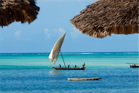 fisherman ship - East Africa; Tanzania; Zanzibar. A dhow is a traditional Arab sailing vessel with one or more lateen sails. It is primarily used along the coasts of the Arabian Peninsula,India,and East Africa. Stock Photo - Rights-Managed, Code: 862-03355270