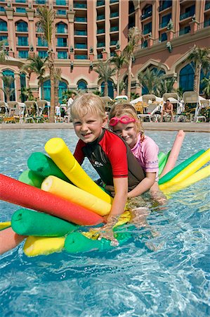 simsearch:862-07910882,k - United Arab Emirates,Dubai,The Atlantis Palm Hotel. Children playing in the hotel's Zero Entry Pool enjoying the winter sun and superb facilities. Stock Photo - Rights-Managed, Code: 862-03355358