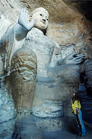 simsearch:400-05119652,k - China,Shanxi Province,Datong. Chinese girl looking at buddhist statues of Yungang Caves cut during the Northern Wei Dynasty (460 AD). Unesco World Heritage site near Datong . Stock Photo - Rights-Managed, Code: 862-03351168