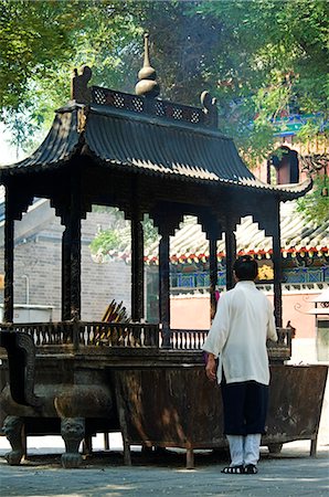 China,Beijing. Incense burning in White Cloud Temple (Baiyun Guan) tended by Taoist monks and founded in AD 739 with todays buildings dating from the Ming and Qing dynasties. Stock Photo - Rights-Managed, Code: 862-03351225