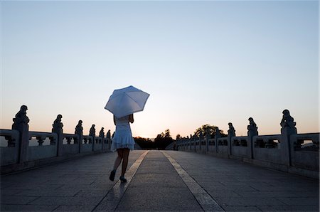 picture of umbrella style - China,Beijing. Summer Palace - Unesco World Heritage Site. A young girl on the 17 arch bridge . Stock Photo - Rights-Managed, Code: 862-03351448